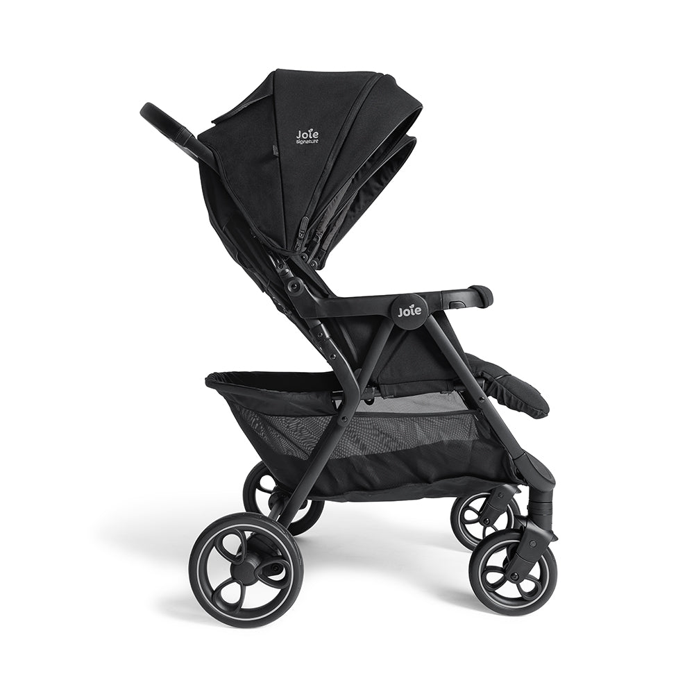 Vista lateral do carrinho duplo Joie Estrella Signature preto, em posição de passeio, destacando o design elegante e a suspensão das rodas.