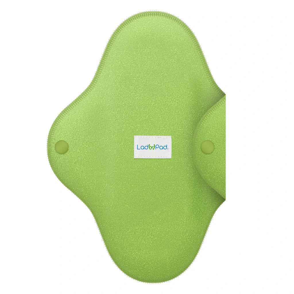 Penso menstrual reutilizável LadyPad de cor verde-lima, aberto, exibindo a superfície têxtil suave e os fechos de pressão laterais.