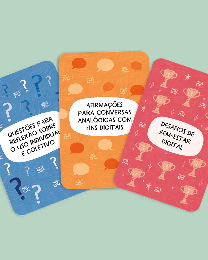 Três cartas do jogo "The Happy Gang - Larga o Telemóvel" com títulos "Questões para reflexão", "Afirmações para conversas analógicas" e "Desafios de bem-estar digital".