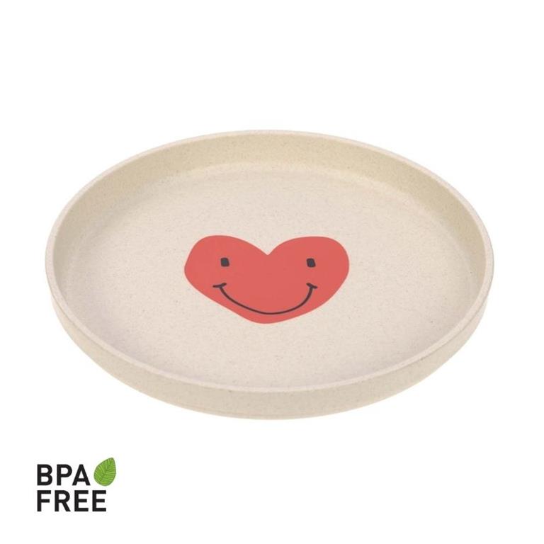 Prato infantil Lassig bege com um grande desenho de coração sorridente vermelho, com selo BPA Free.