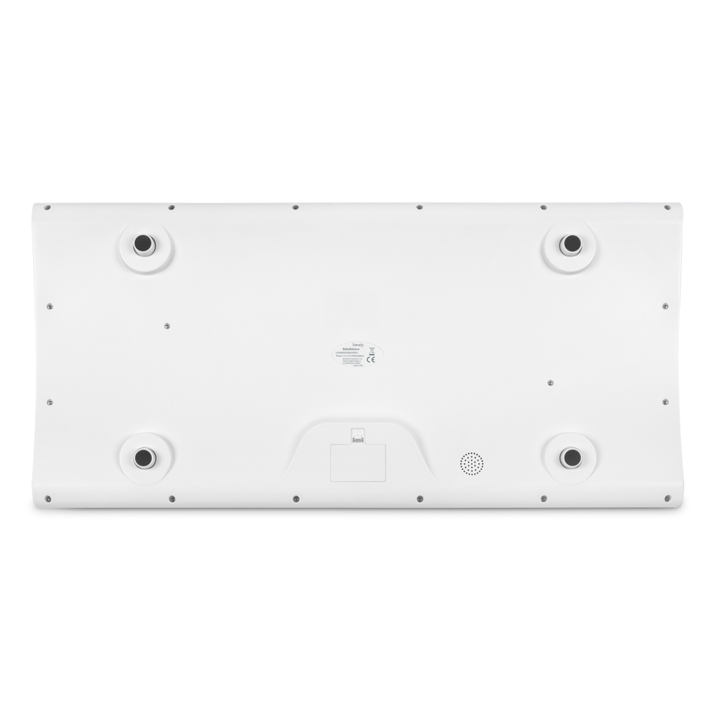 Vista inferior da balança Lionelo BabyBalance White, mostrando os quatro pés antiderrapantes e o compartimento das pilhas.