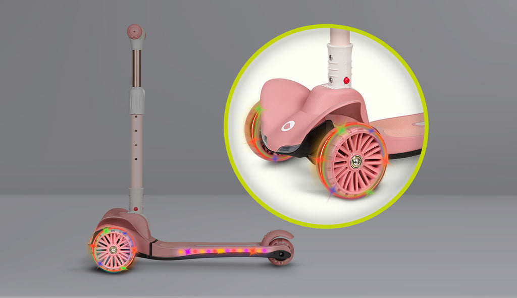 Detalhe das rodas iluminadas da trotinete Lionelo Timmy rosa, com luzes LED coloridas em ação durante o movimento.