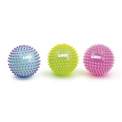 Três bolas sensoriais Ludi com relevos, nas cores azul-claro, verde-lima e rosa, sobre fundo branco.
