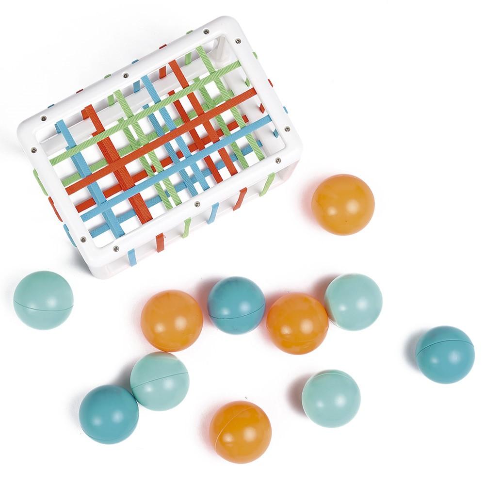 O cubo Ludi em uso, mostrando como os elásticos esticam para permitir a passagem das bolas coloridas, estimulando a destreza.