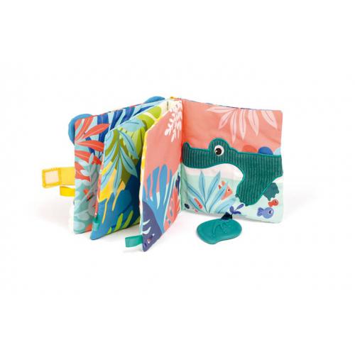 Livro de atividades em tecido Ludi Selva aberto, destacando a página com um crocodilo verde em relevo e um mordedor em forma de folha.