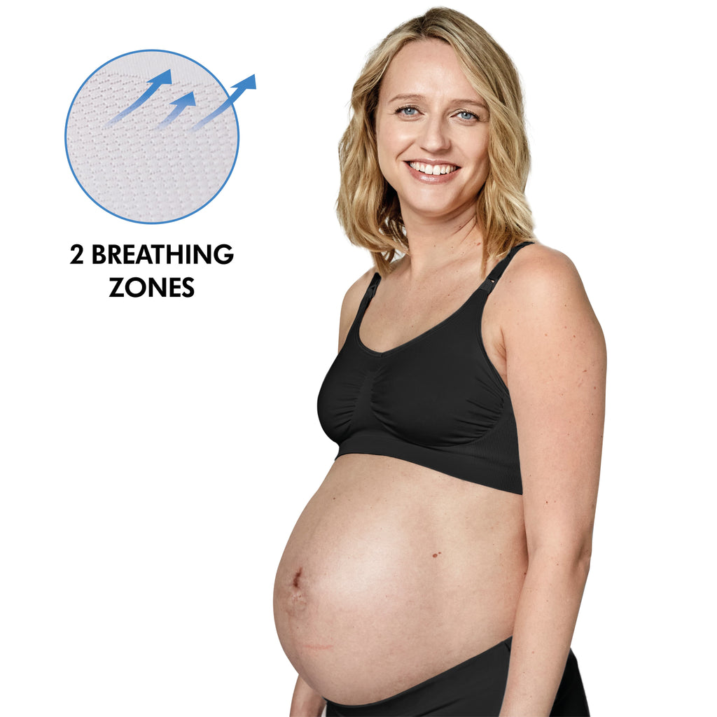 Grávida sorridente a usar o sutiã Medela preto, com destaque para o círculo que ilustra as 2 zonas respiráveis do tecido.