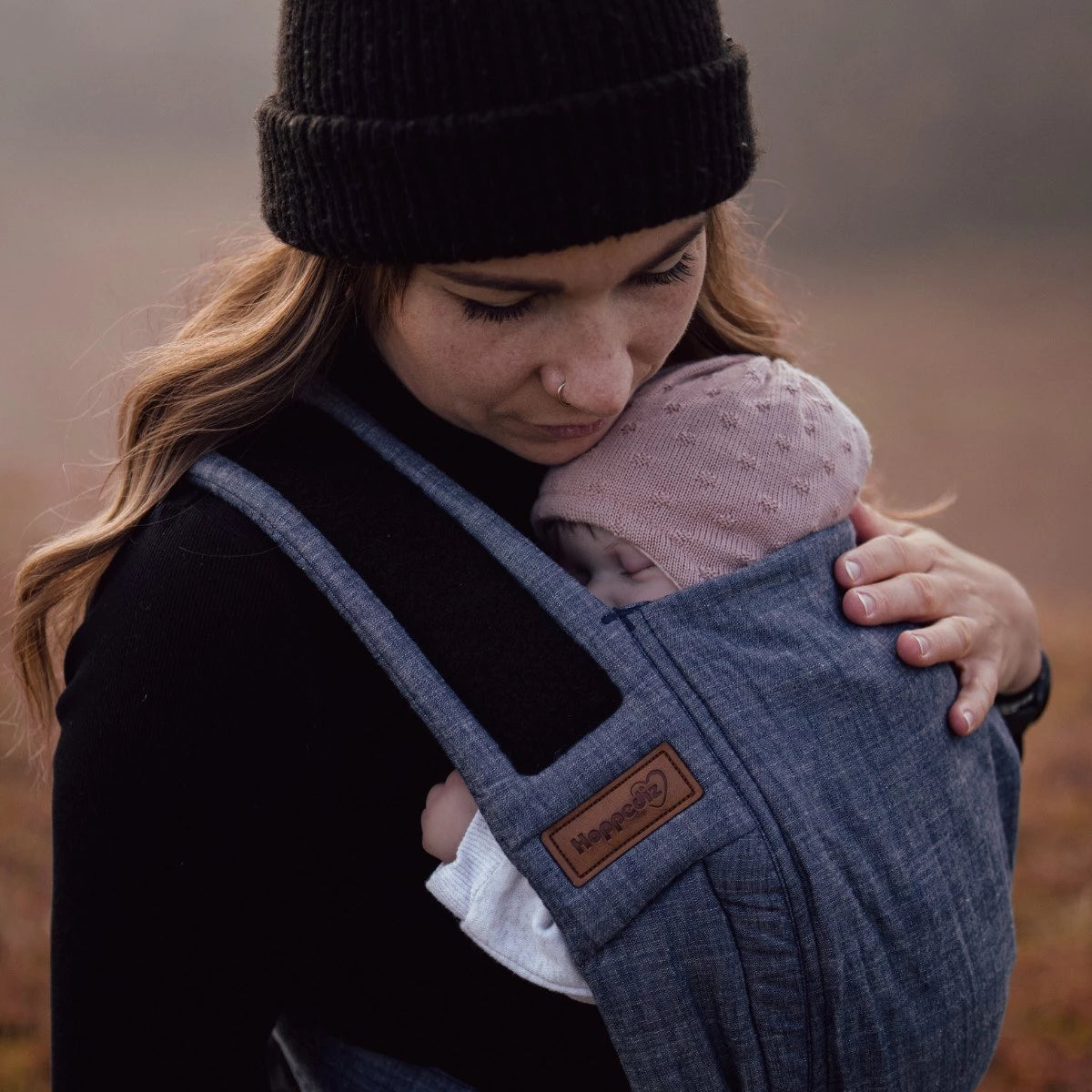 Close-up da secção do corpo do Mei Tai Hoppediz, destacando a qualidade do tecido B.Pure Denim e o painel que sustenta a anca do bebé.