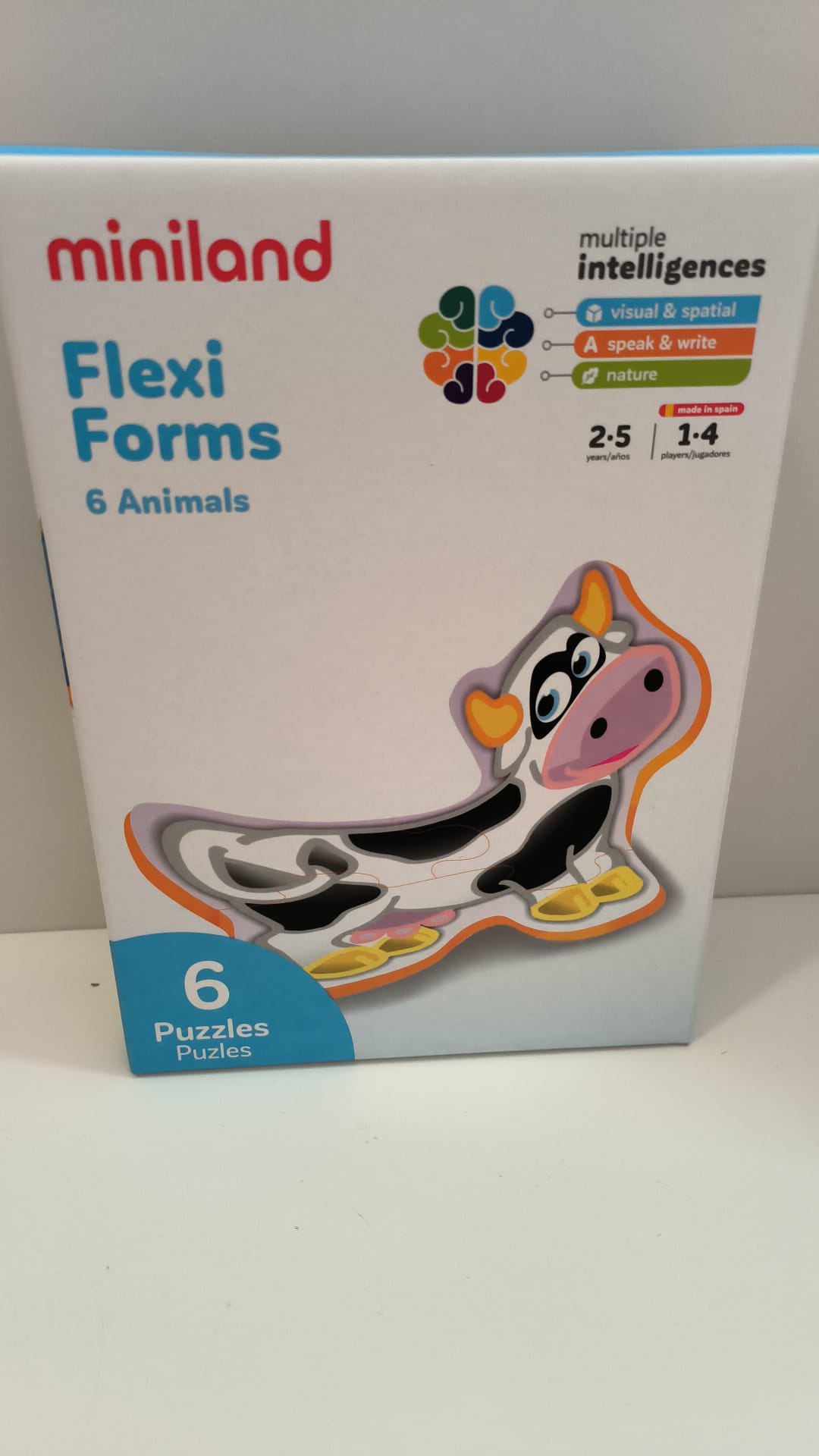 Caixa do puzzle Miniland Flexi Forms Animais, mostrando o design flexível e as habilidades de inteligências múltiplas que desenvolve (visual, fala, natureza).