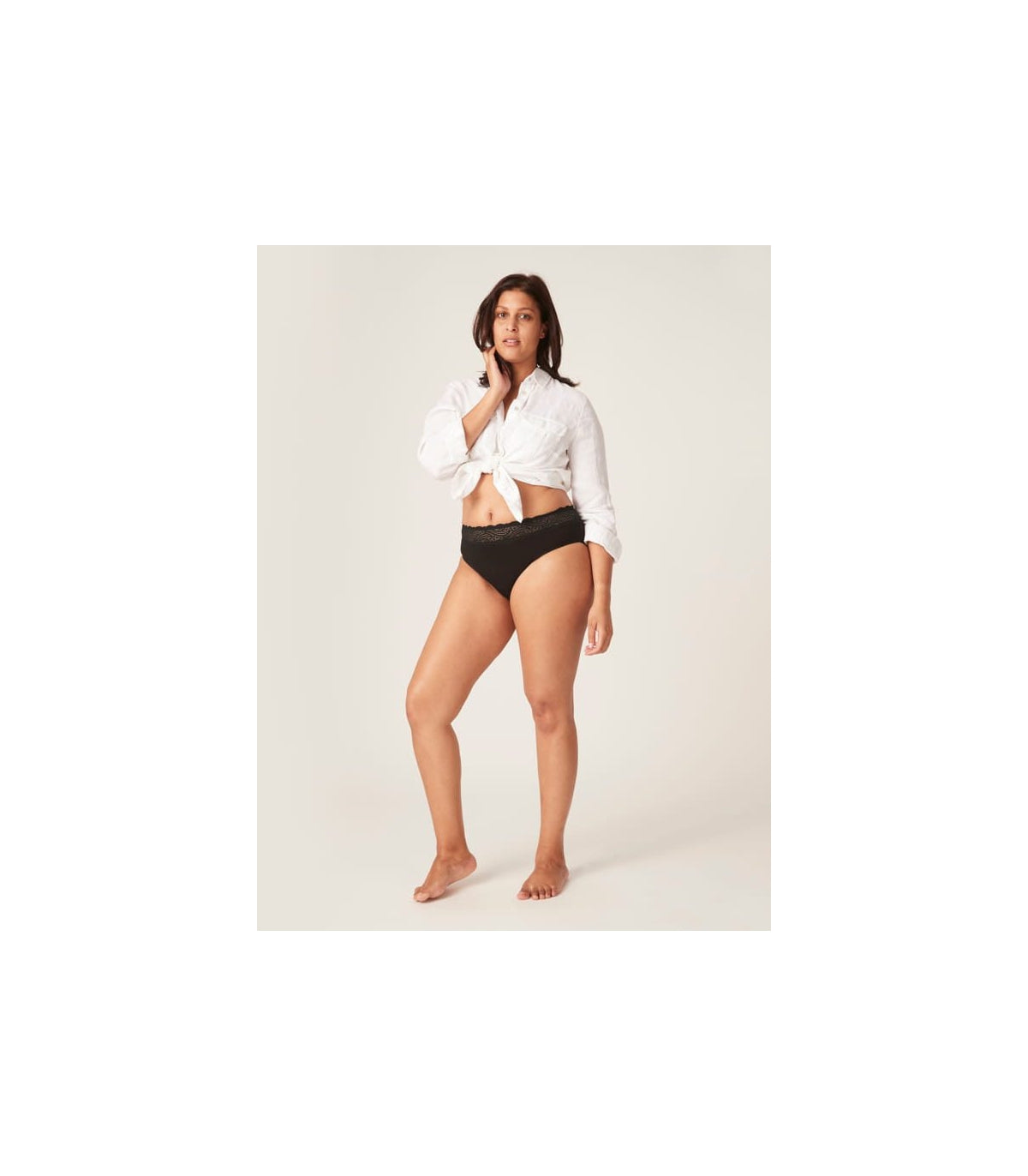 Modelo usando a cueca menstrual Modibodi preta de cintura alta, mostrando o comprimento e ajuste da peça.