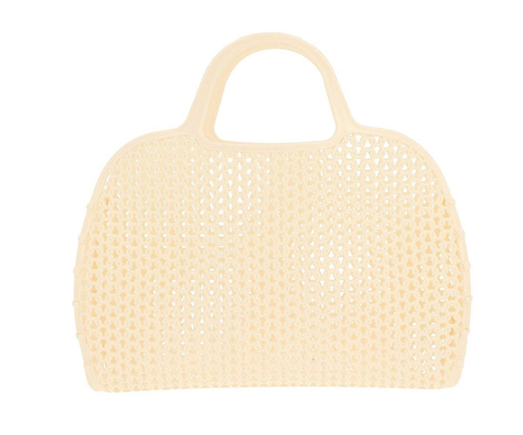 Bolsa de praia Monneka Jelly Retro em cor creme ou amarelo muito claro, com padrão vazado que permite a drenagem da areia e água.