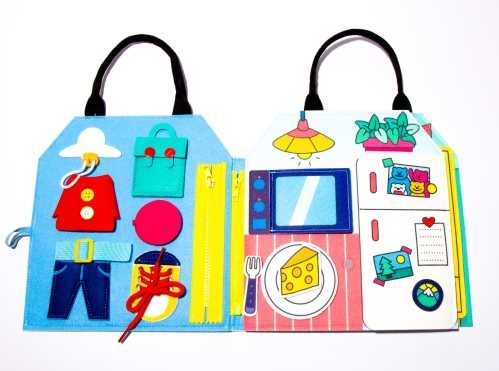 OMY Livro Play Kit Montessori aberto, mostrando as atividades de amarrar cordões e fechar zíperes.