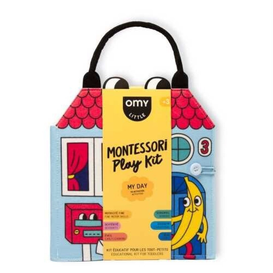 OMY Livro Play Kit Montessori "My Day" fechado, mostrando a capa com um design de casa e o título. Ideal para crianças a partir dos 3 anos.