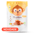 Embalagem amarela e branca do preparado para panquecas "Pre-feitinhos" da Papinhas da Xica com desenho de macaco e panquecas. Destaque "NOVIDADE".