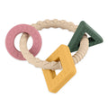 Mordedor de silicone Petite and Mars com formas geométricas (anel, quadrado, triângulo) em tons pastel de rosa, amarelo, verde-escuro e bege.