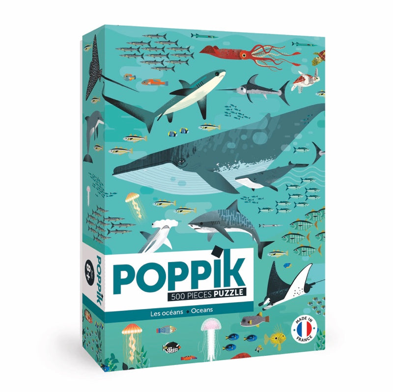 Caixa do Poppik Puzzle Ocean de 500 peças, ilustrada com diversos animais marinhos como baleia, tubarões e lulas, em tons de azul e verde.