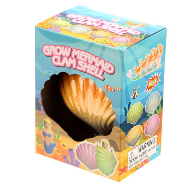 Embalagem da Concha Mágica Sereia da Puckator, exibindo uma concha laranja listrada visível através de um recorte frontal. O design é azul e subaquático.