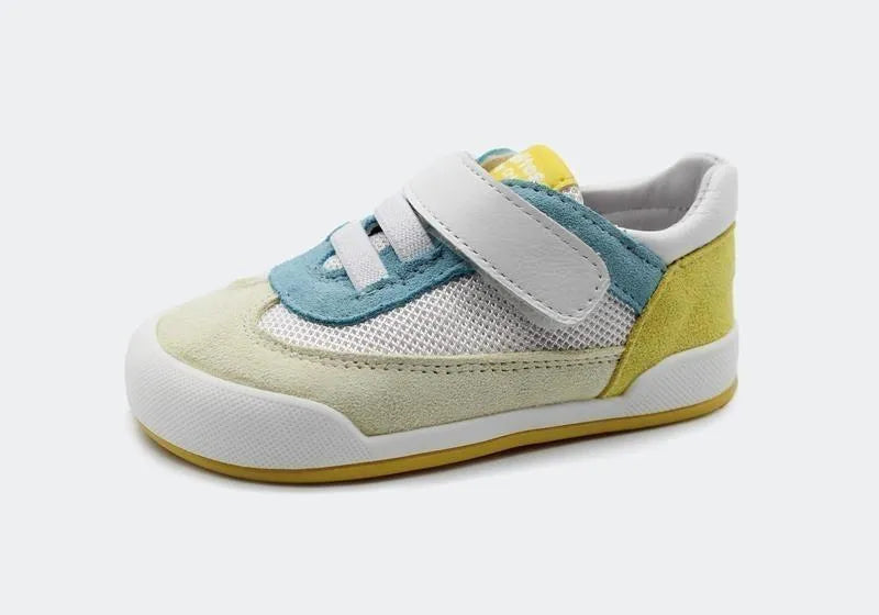 Vista de lado da sapatilha Blanditos Modena 2025 Amarelo (amarelo, azul claro, branco). Calçado barefoot e respeitador para criança, com sola zero drop e velcro.