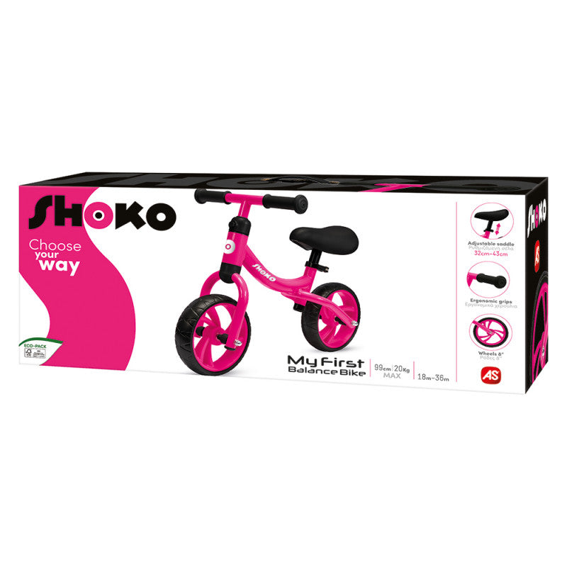 Embalagem da bicicleta de equilíbrio Shoko MyFirst cor-de-rosa, destacando características como selim ajustável e rodas EVA.