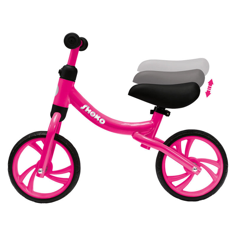 Bicicleta de equilíbrio Shoko rosa, mostrando o selim ajustável em altura com indicação gráfica de movimento vertical.