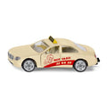 Miniatura SIKU de um táxi cor de creme, vista lateral, com decalque vermelho "HEY TAXI!" e letreiro amarelo "TAXI" no tejadilho.