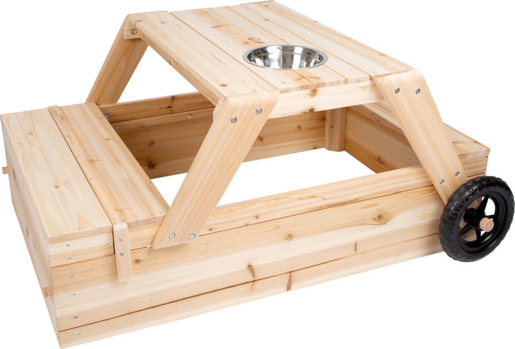 Mesa caixa de areia e cozinha de lama Small Foot em madeira, mostrando a estrutura dobrável com tigela metálica central e roda lateral.