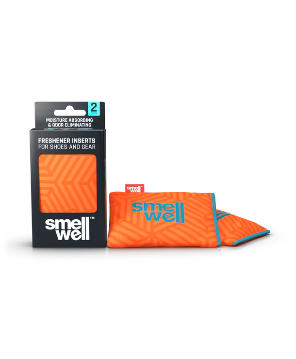 Embalagem e dois sacos SmellWell Active com padrão geométrico (laranja e azul claro) para absorver humidade e odores.