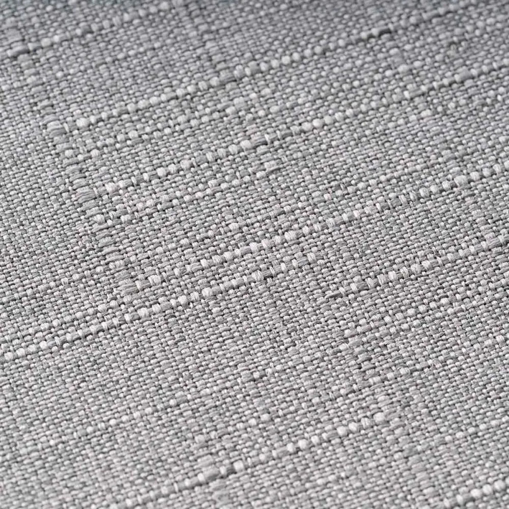 Close-up da textura do tecido exterior cinzento (Merle) da caixa TAVO Crispin, mostrando o entrelaçado robusto e durável.