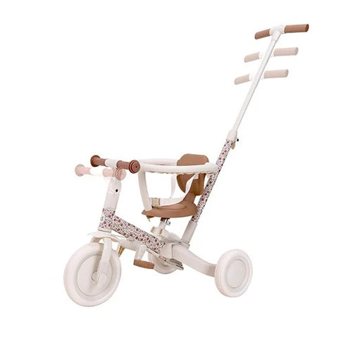 Triciclo Little Dutch em modo assistido, mostrando a barra de empurrar com diferentes níveis de ajuste de altura.