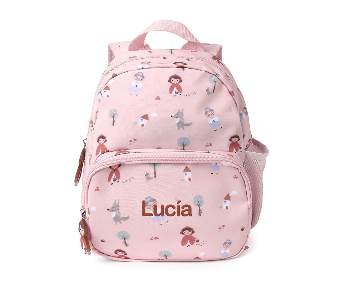Mochila infantil Tutete cor-de-rosa com padrão "Capuchinho Vermelho" personalizada com o nome "Lucía" em castanho.