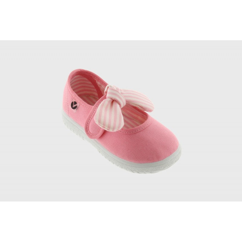 Sapato infantil Victoria com laço listrado em tom flamingo (rosa) e fecho de velcro, exibido em perspetiva.