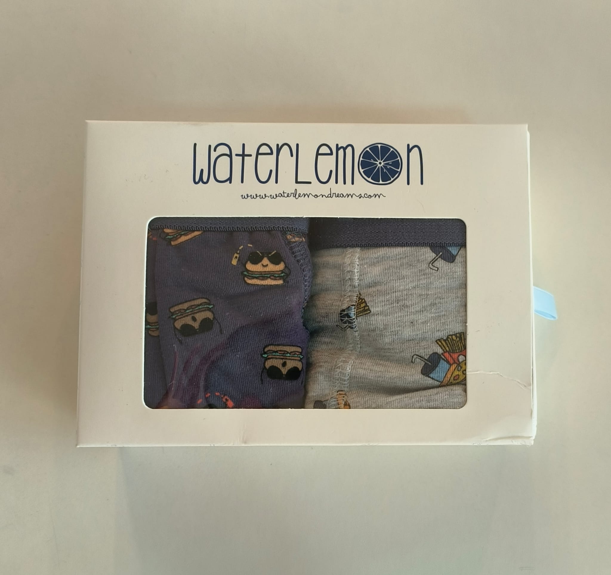 Conjunto de 2 boxers Waterlemon para homem na embalagem, exibindo um boxer roxo com hambúrgueres e um cinzento com batatas fritas.