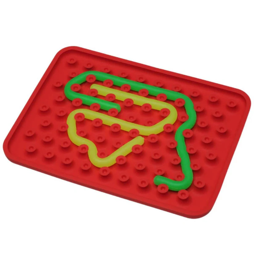 Wiggly Toy Jogo Sensorial vermelho com peças flexíveis verde e amarela, demonstrando a versatilidade do encaixe sensorial.