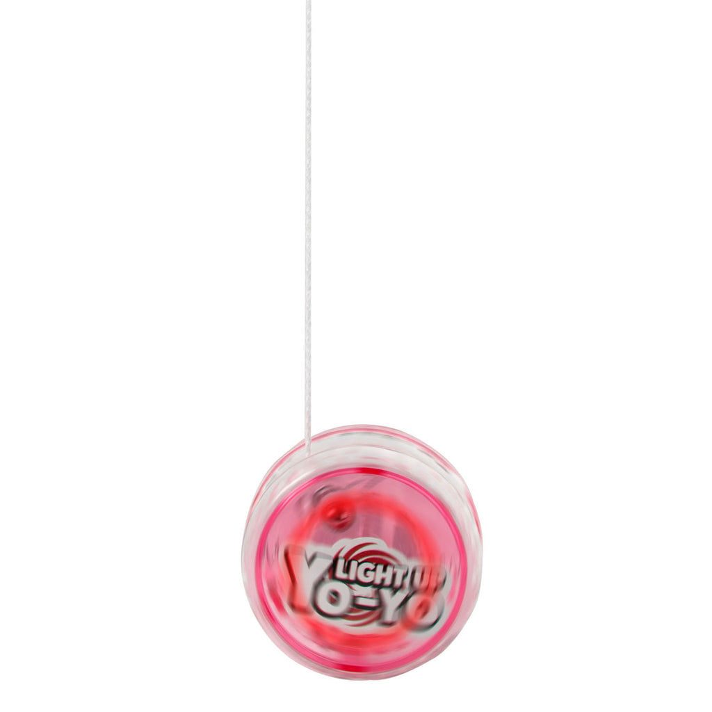 Yo-Yo de plástico rosa em movimento, com corda branca visível, capturado durante uma rotação.