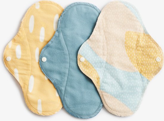 Conjunto de três pensos menstruais reutilizáveis ImseVimse Dia SPRINKLE em tons de amarelo, azul e bege com padrões abstratos e botões de pressão brancos.