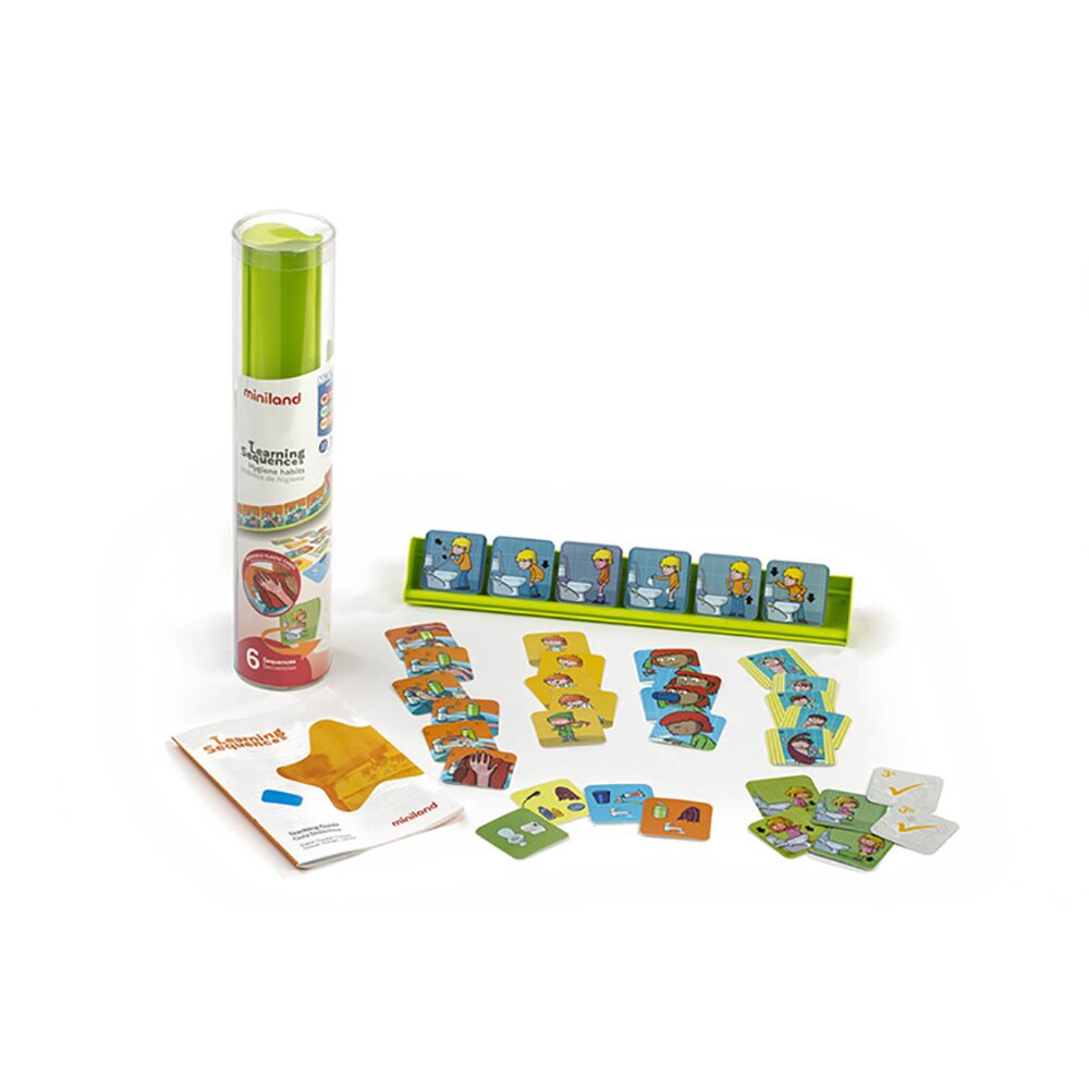 Conteúdo completo do jogo Miniland Hábitos de Higiene, incluindo o tubo da embalagem, o suporte verde e os vários cartões de sequências espalhados.