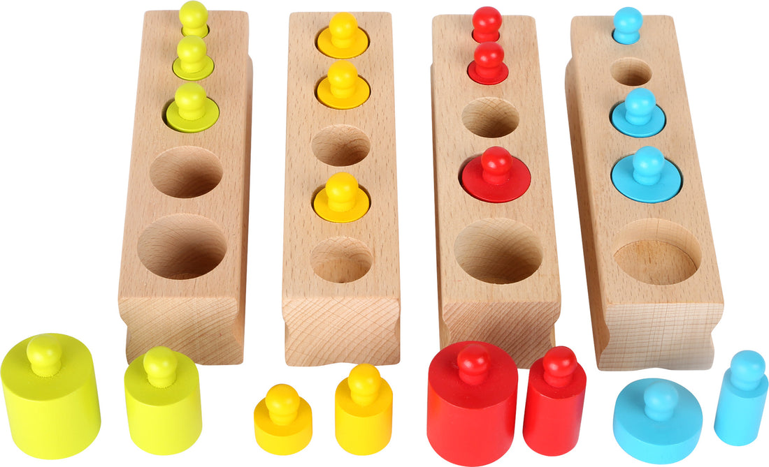Conjunto de blocos de cilindros de madeira coloridos em quatro cores diferentes, com cilindros de diferentes tamanhos e uma base de madeira para encaixe.