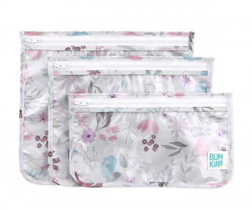 As três bolsas transparentes Bumkins lado a lado, com uma delas aberta a exibir o interior, ideais para organização de viagem ou artigos de bebé.