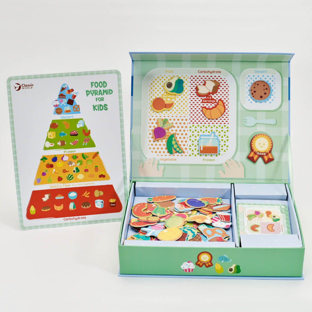 Jogo educativo Classic World Alimentação Saudável aberto, mostrando peças magnéticas e guia da pirâmide alimentar.