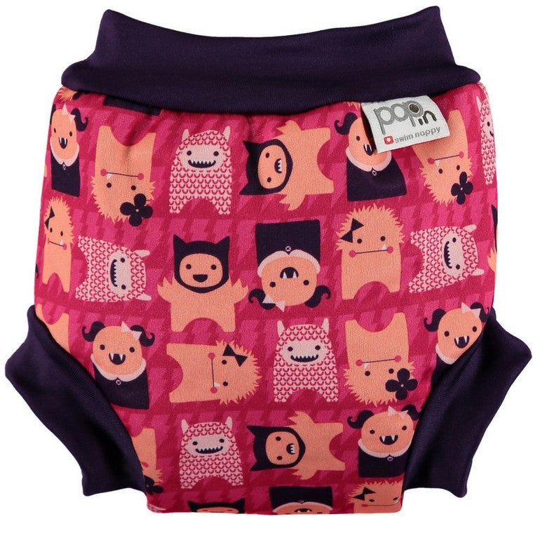 Cueca/fralda de banho reutilizável Close Pop-in Monstros Edie tamanho S (0-3 meses), vista superior, com padrão de monstros coloridos sobre fundo rosa.