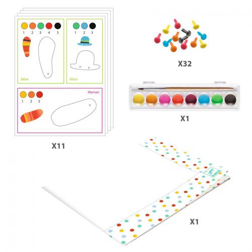 Detalhe dos componentes do kit de pintura: folhas com peças pré-cortadas, paleta de tintas, brads e toalha protetora.
