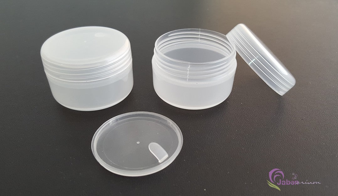 Detalhe da rosca do frasco raso transparente, mostrando o encaixe seguro da tampa branca para cosméticos.