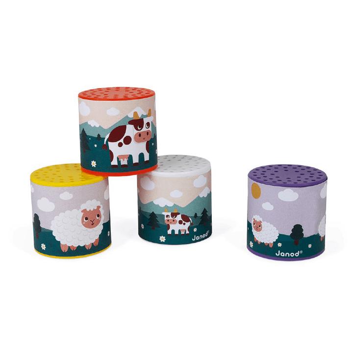 Caixas de sons Janod empilhadas e lado a lado, mostrando os desenhos de vaca e ovelha.