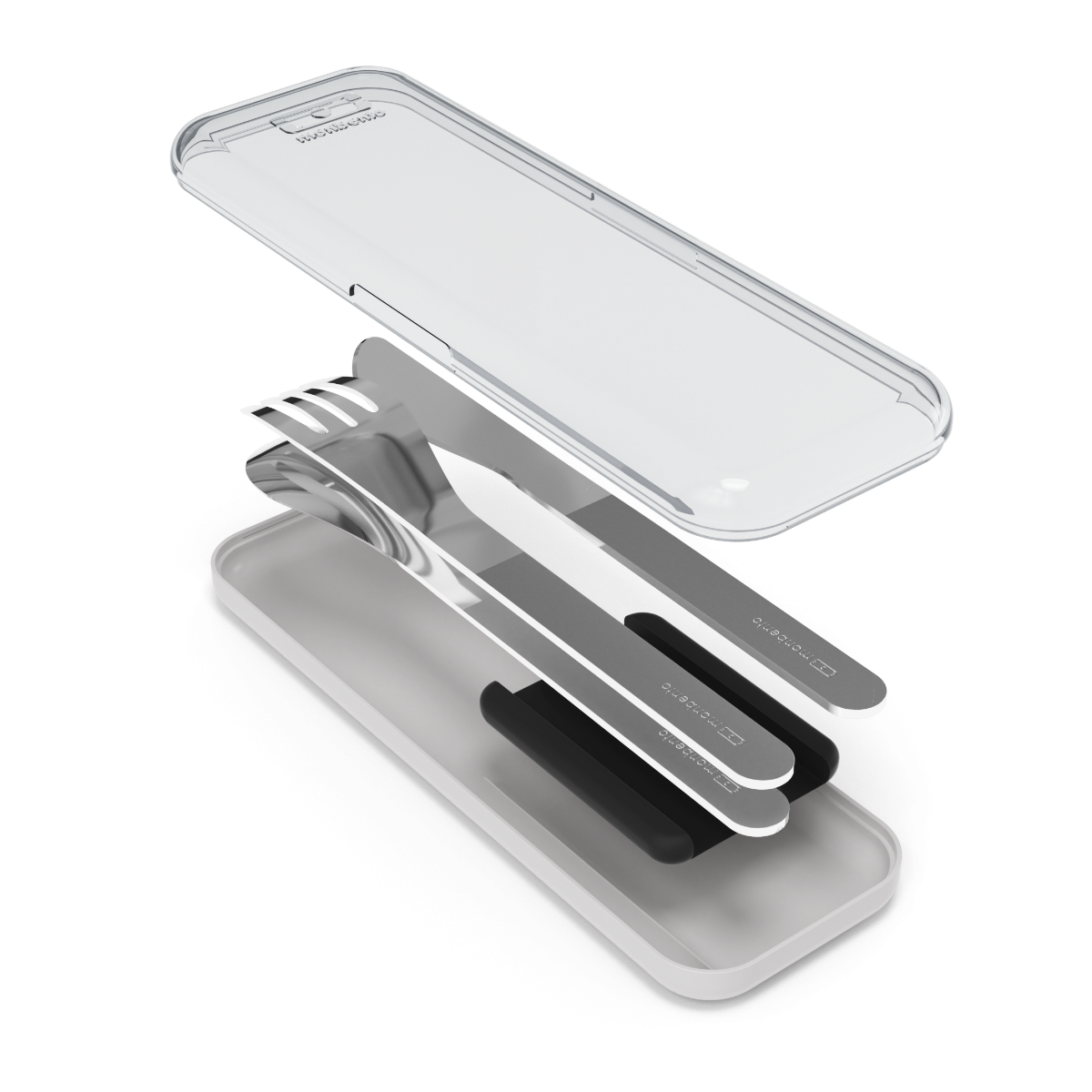 Os talheres Monbento (faca, garfo, colher) dispostos lado a lado, com a caixa de proteção PP/PC transparente ao fundo.