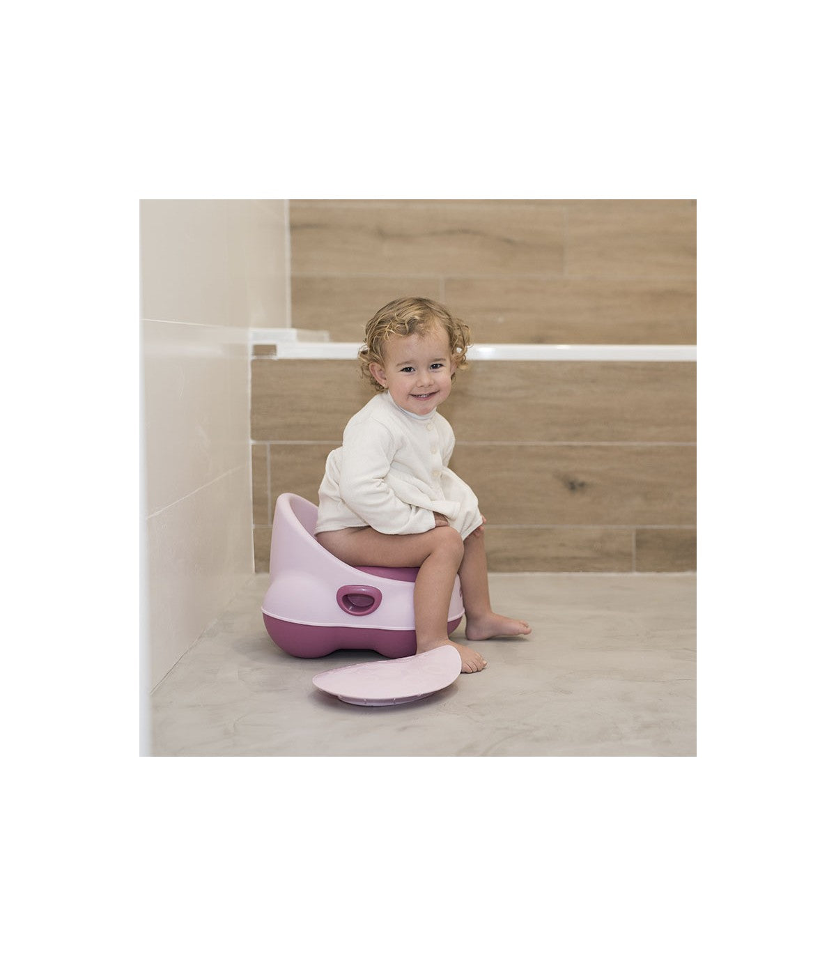 Olmitos Pote Sanita WC Anatómico em branco, visto de frente, com base antiderrapante escura e assento ergonómico para treino de desfralde.