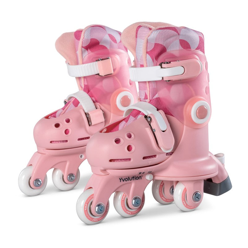 Par de patins infantis Yvolution Twista cor-de-rosa com padrão circular, configurados com quatro rodas paralelas para iniciantes.