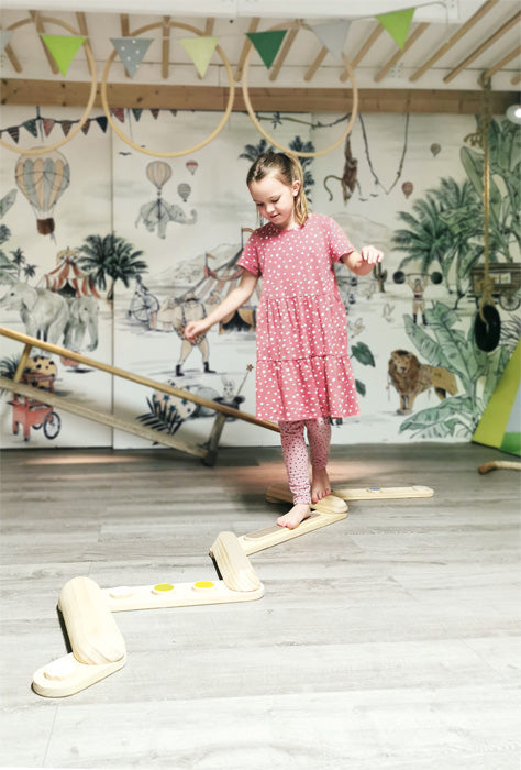 Conjunto completo das 7 vigas de equilíbrio em madeira natural com detalhes coloridos, prontas a serem montadas.