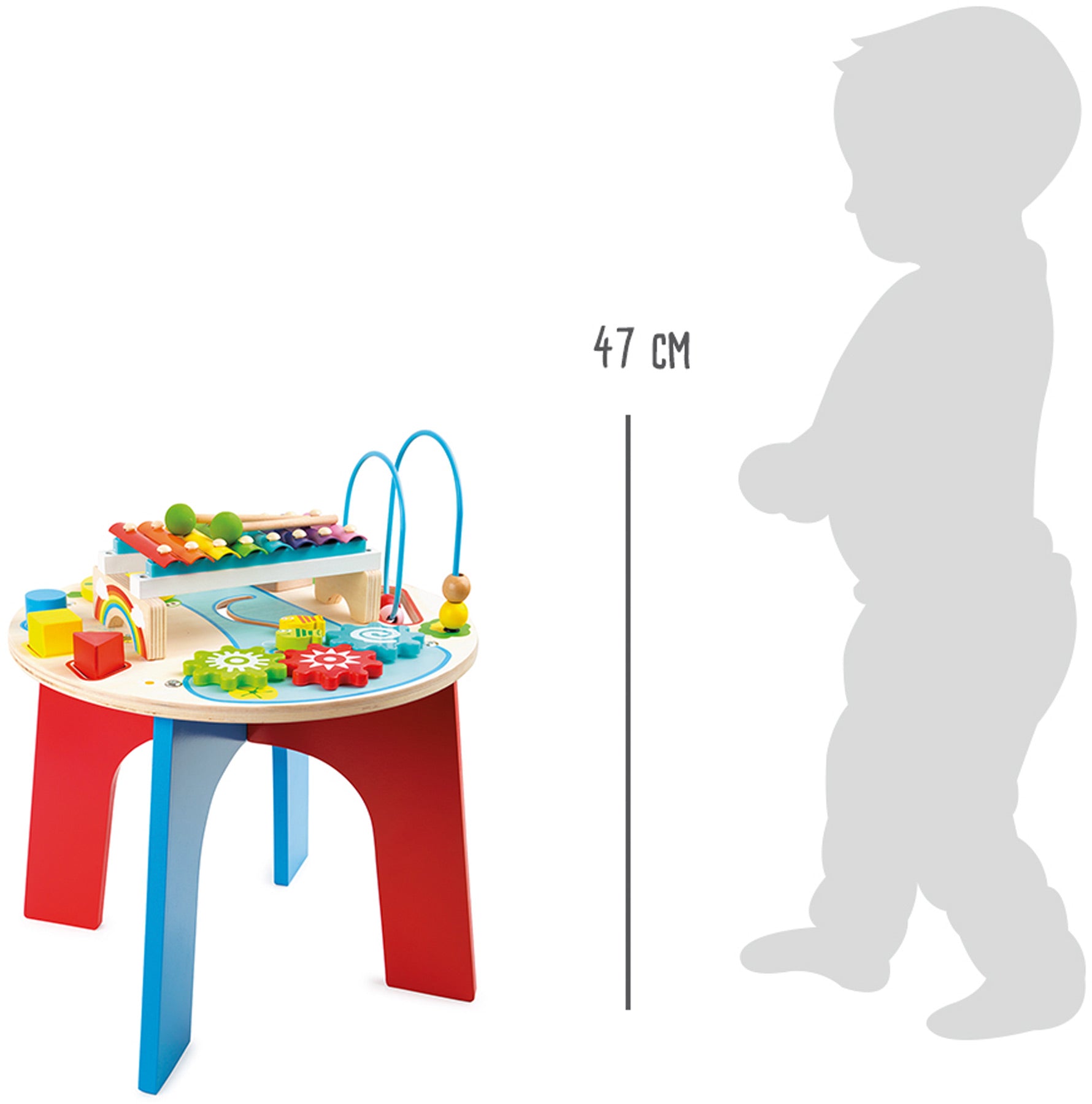 Comparação de tamanho da mesa de atividades musical 2 em 1 da small foot com uma criança, mostrando as dimensões aproximadas do brinquedo.