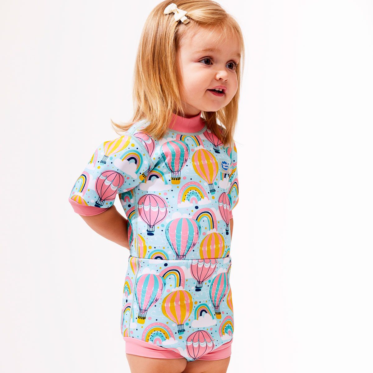Fato de natação térmico Splash About Happy Nappy, modelo em cor verde-água com padrão de bolhas, exibido dobrado para mostrar a espessura do neoprene.