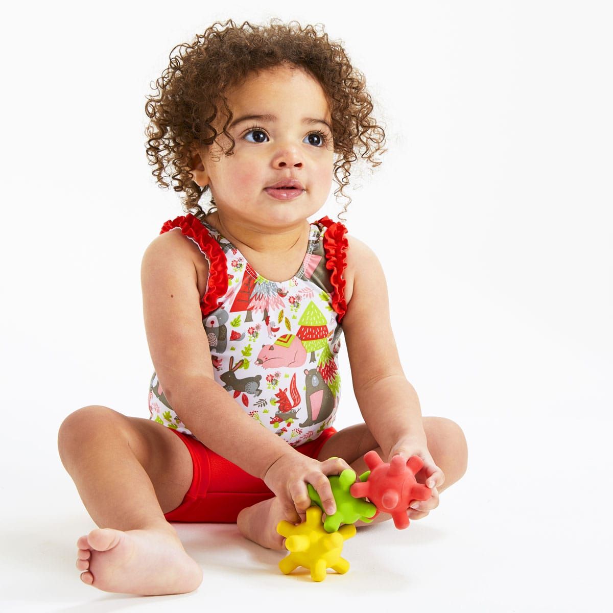 Detalhe dos três brinquedos Splash Jacks Meteoritos, mostrando a textura de borracha natural e as cores primárias vibrantes.