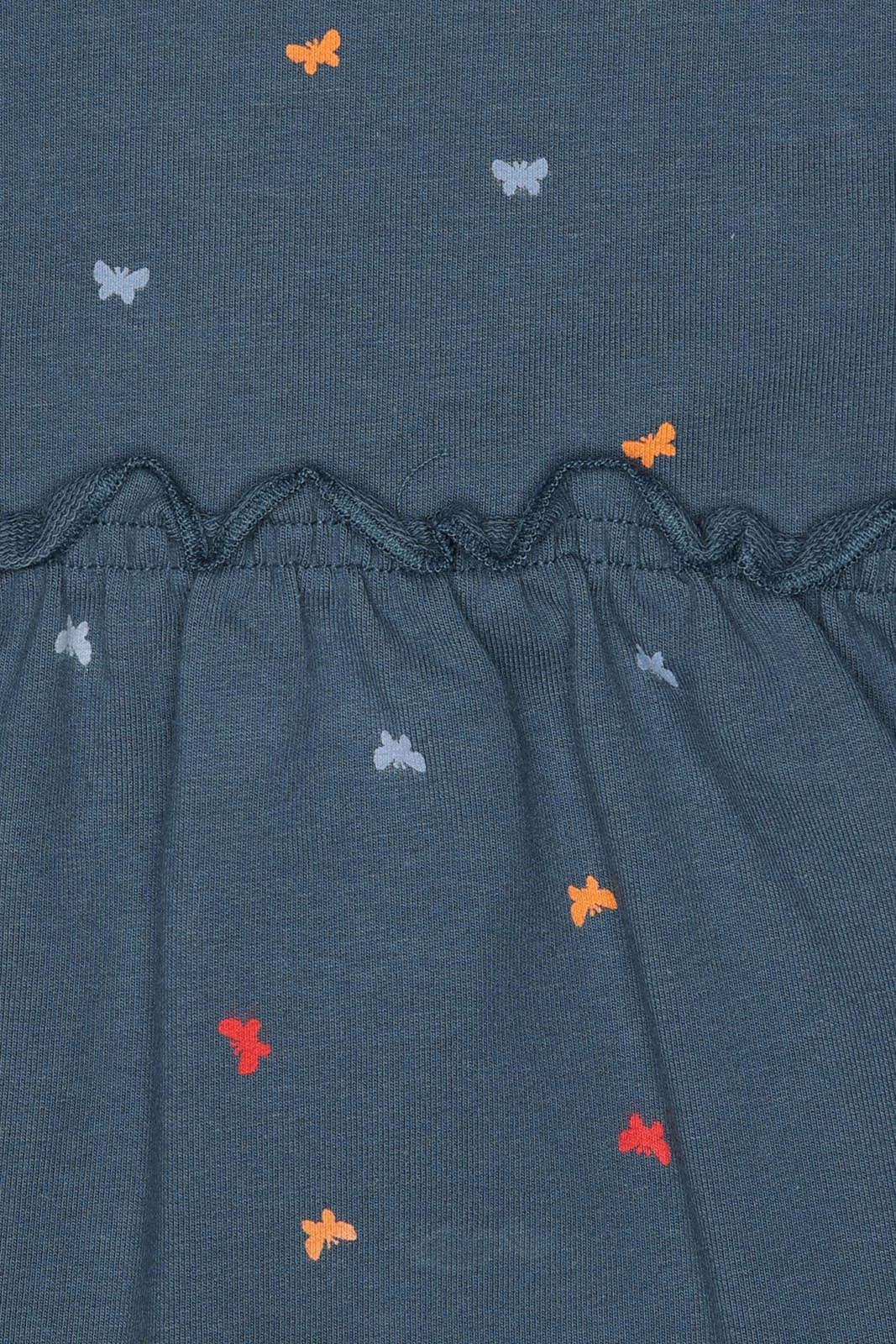 Detalhe das costas do vestido Street Monkey, focando no fecho de correr plástico interno, essencial para o vestir e despir.